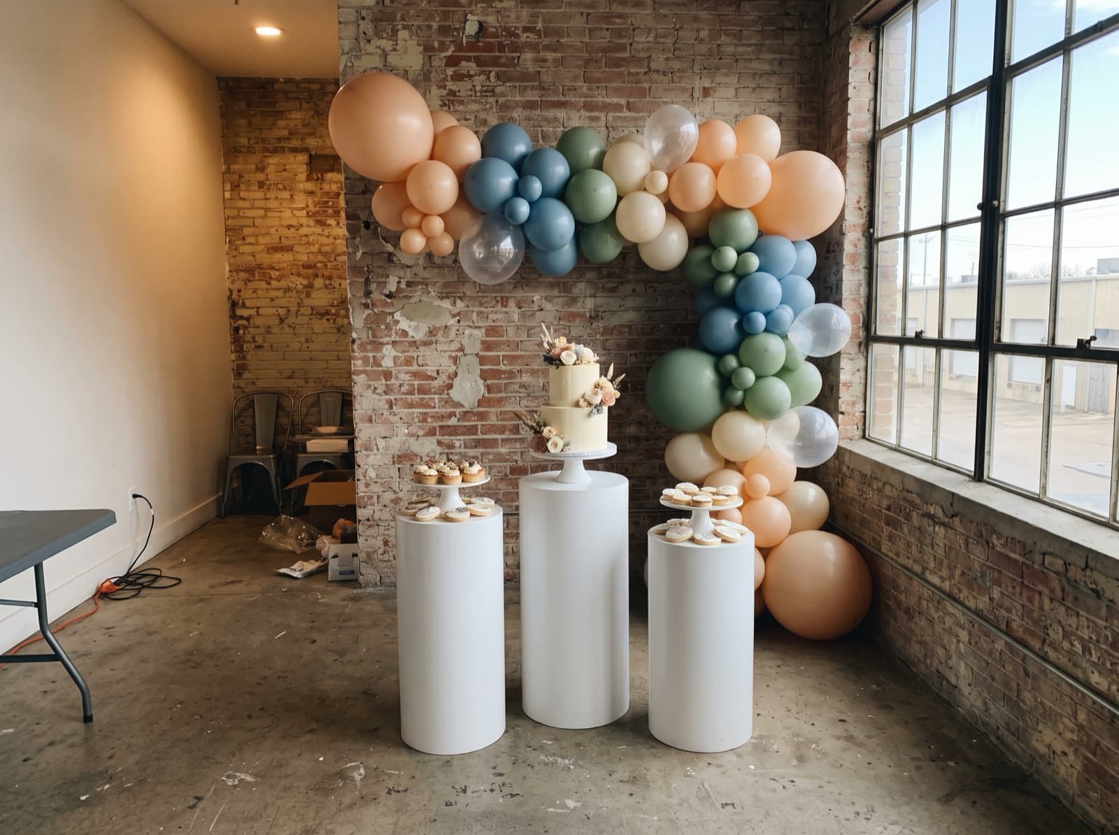 Backdrop with pedestals and a cake table