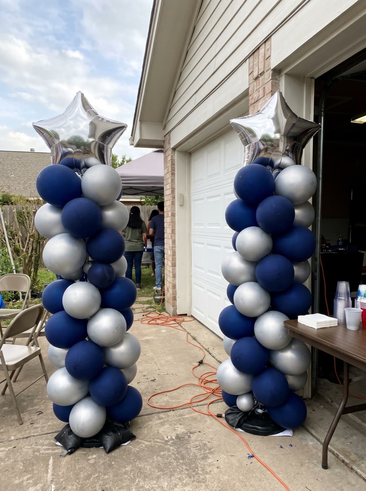 Balloon columns with silver star toppers for a graduation
