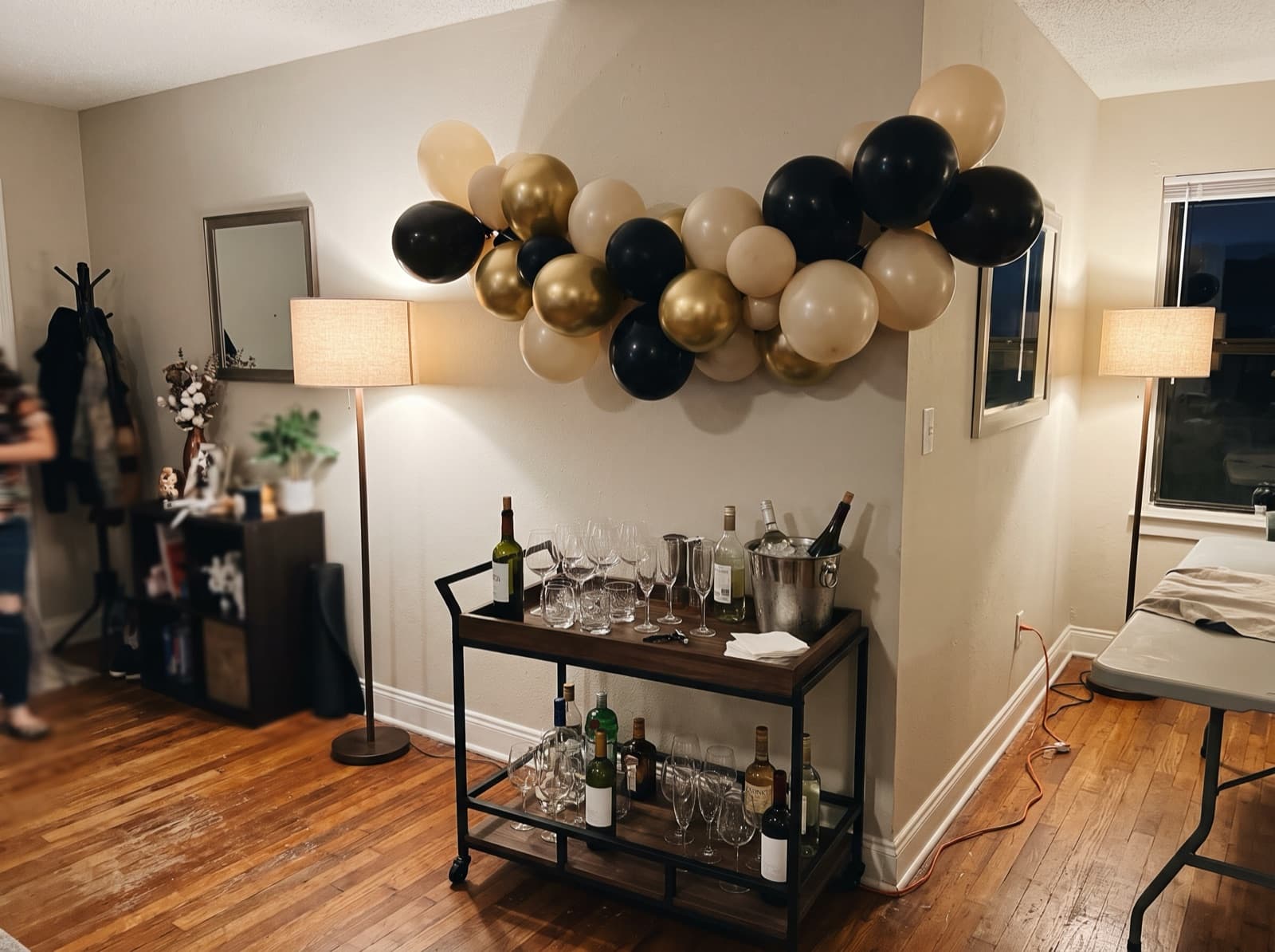 Chrome gold and black garland above a bar cart at a New Year's Eve party