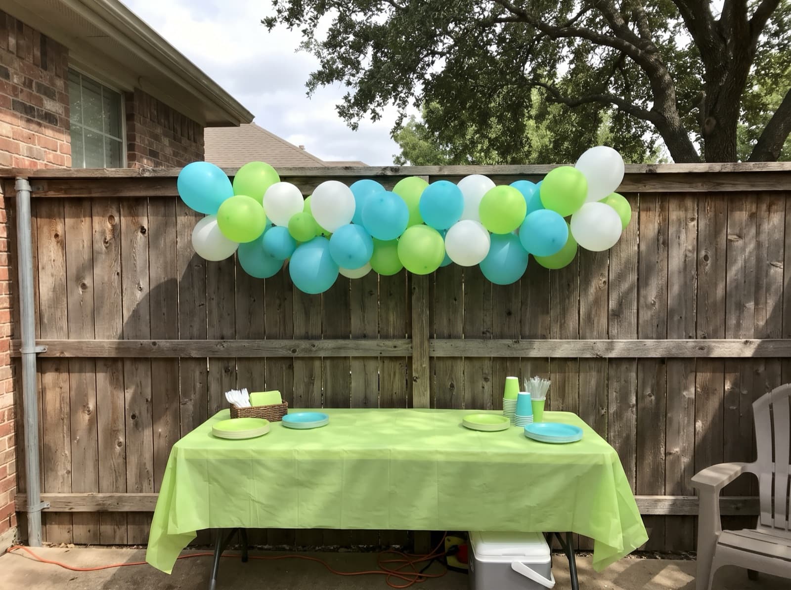Balloon garland on a backyard fence