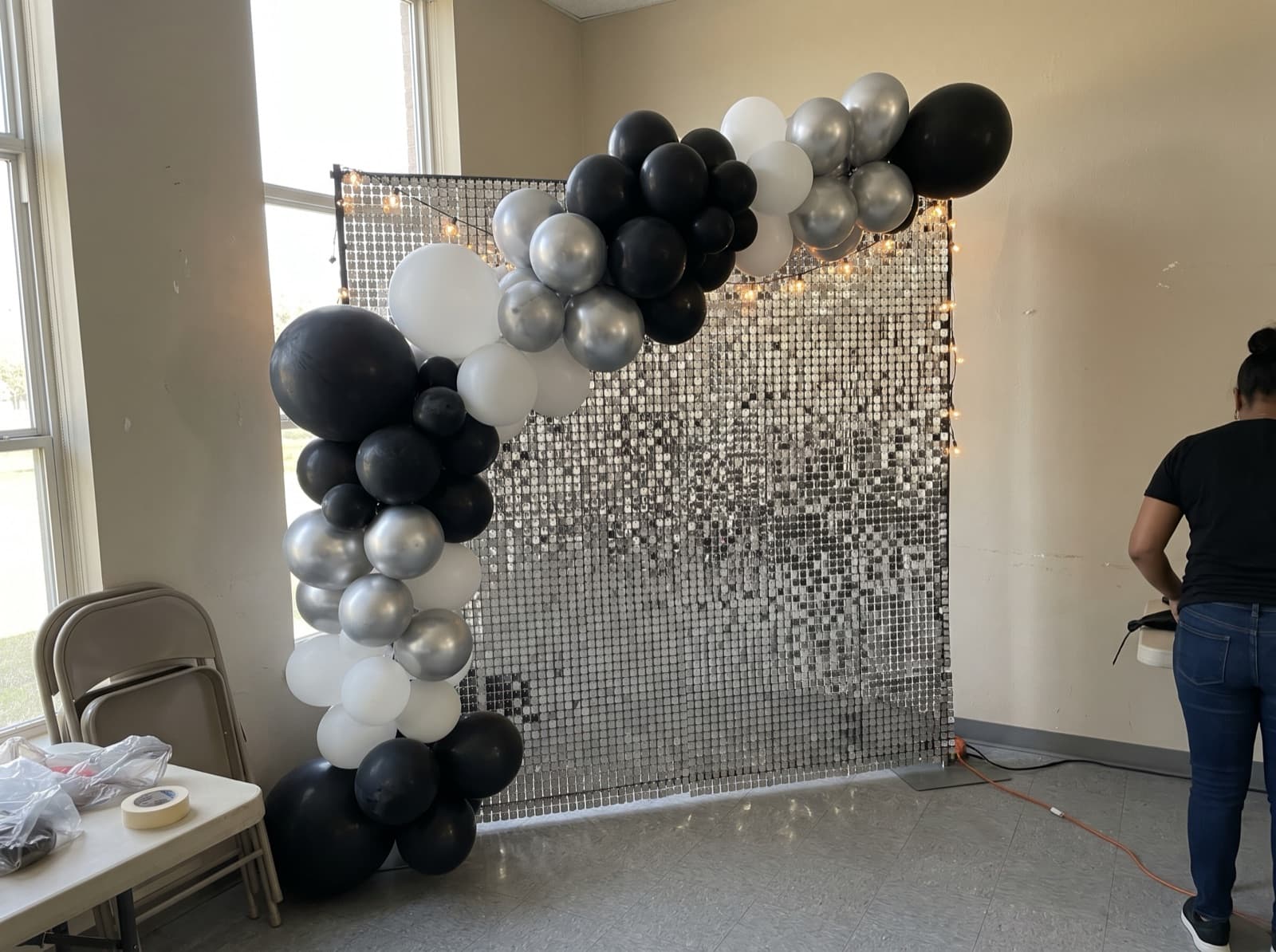 Balloon garland over a silver shimmer wall