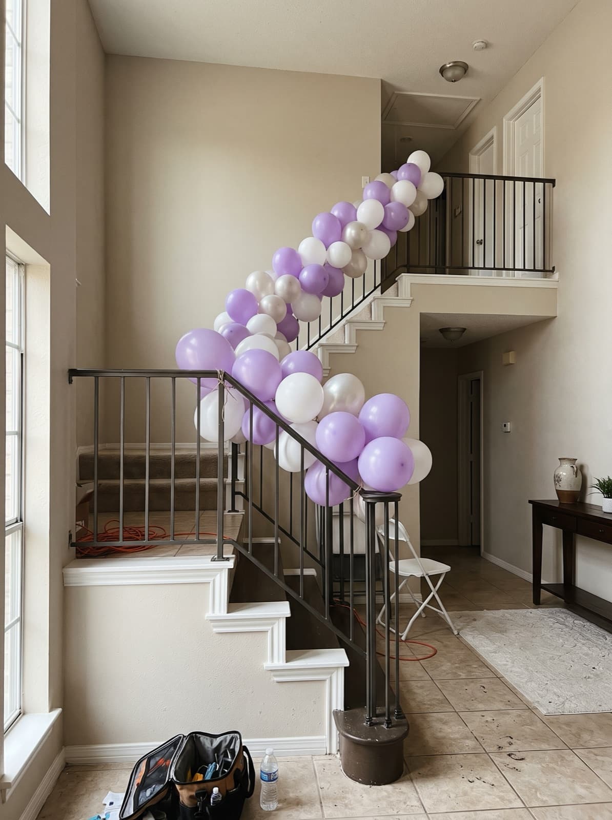 Balloon garland running down a staircase banister