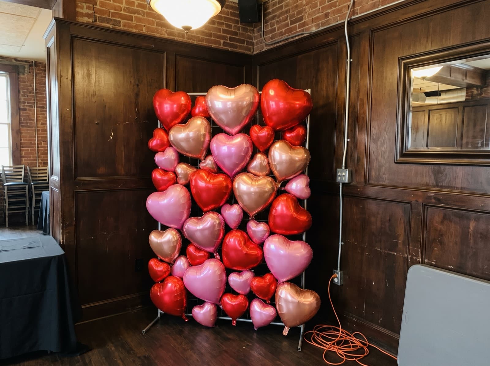 Foil heart balloon wall in red and pink